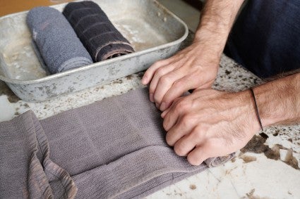 Rolling up a kitchen towel for bread baking