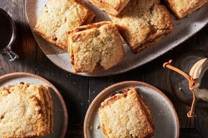 Baked scones cut into squares on various plates. 