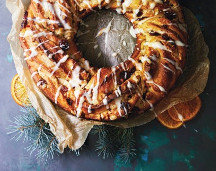 Cranberry Orange Holiday Bread shaped in a wreath, drizzled with white sugar glazee.