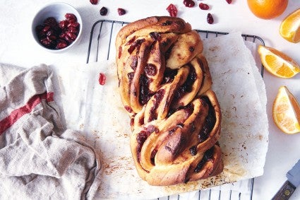 Baked loaf of babka sitting on a cooling rack. 