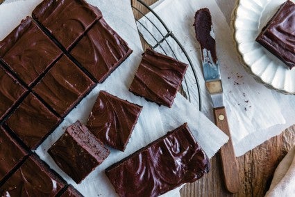 Offset spatula next to frosted brownies