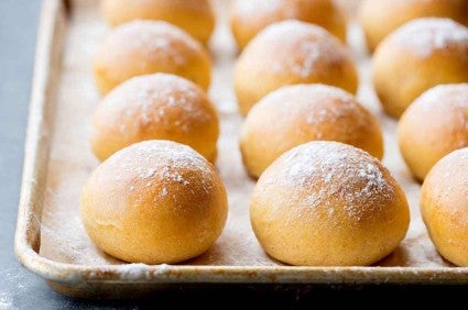 Tray of sweet potato rolls dusted with flour. 