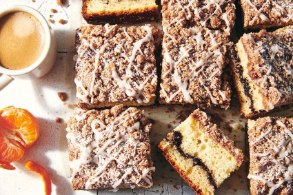 Slices of Cinnamon-Crisp Coffee Cake dusted with confectioners' sugar and drizzled with glaze