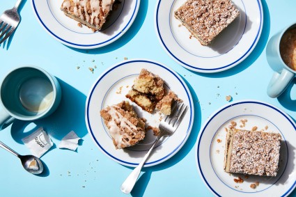 Slices of gluten-free cinnamon-crisp coffee cake on plates with forks