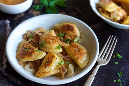 Bowl of pierogis on a table.  