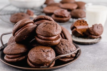 Plate of mocha whoopie pies on a table.