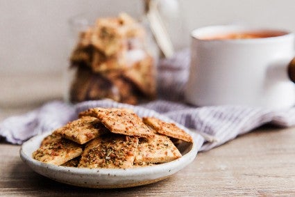 A plate of crunchy, cheesy parmesan crackers on a kitchen table