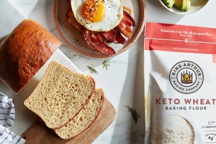 Sliced keto bread next to keto wheat flour