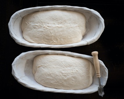 Two oval bannetons full of bread dough 