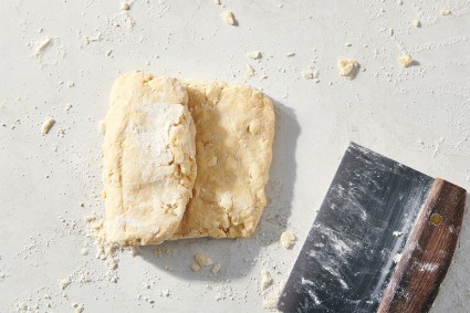 Biscuit dough being folded like a letter