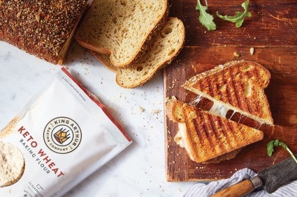 Sliced keto bread next to keto grilled cheese and keto wheat flour