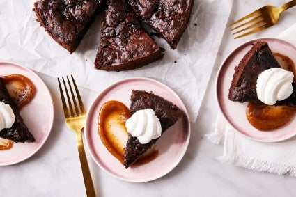 Chocolate Date Cake sliced and served with whipped cream