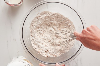 Baker whisking bowl of rye flour