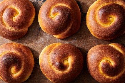 Baked mallorcas, before they get a shower of confectioners' sugar