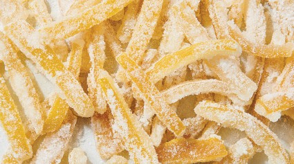 Close-up shot of candied lemon peel coated in sugar.