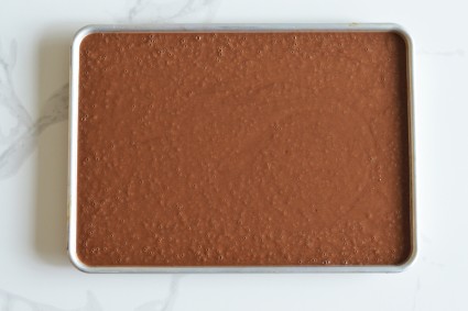 Chocolate cake batter in a half-sheet pan