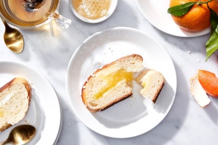 A slice of braided lemon bread on a plate, filled with lemon curd