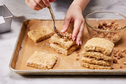 Assembling a scone loaf with layers of dough and layers or streusel