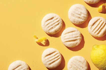 Shortbread cookies fused with lemon paste on a yellow background