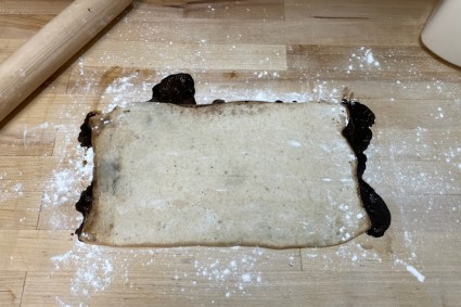 Flat, leaky cardamom buns dough rolled into a rectangle