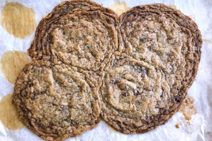 Four cookies that have spread while baking and baked together