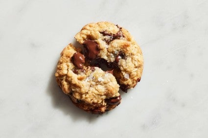 Closeup of a coconut oil chocolate chip cookie broken in half