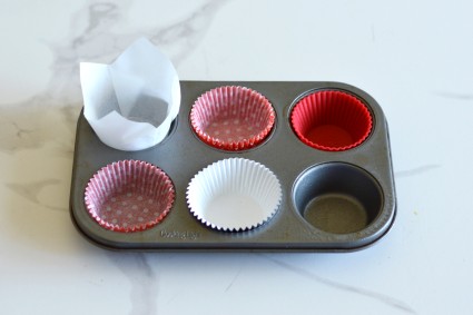 A six-cup muffin pan with different liners in each well