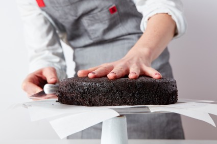Baker slicing cake in half