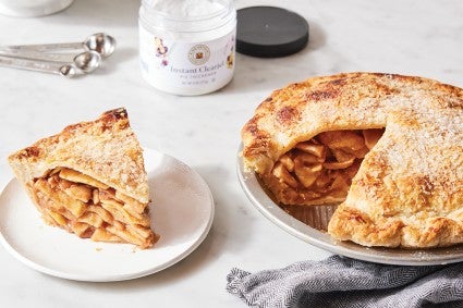 Sliced apple pie with container of Instant ClearJel in the background