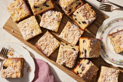A freshly baked sweet corn and blueberry coffee cake, cut into pieces, ready to serve