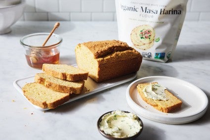 Sliced cornbread in front of bag of organic masa harina