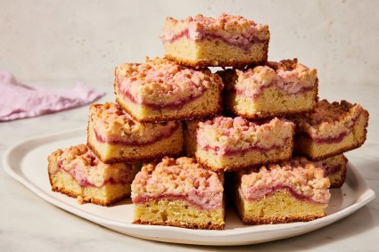 A stack of slices of raspberry cream cheese coffee cake on a platter