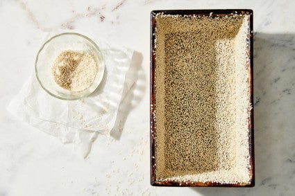 Loaf pan with sesame seeds coating the interior