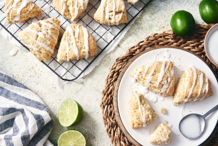 Plate of baked scones with lime glaze drizzled on top. 