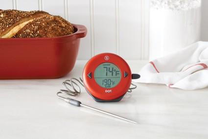 Thermometer in front of loaf of bread