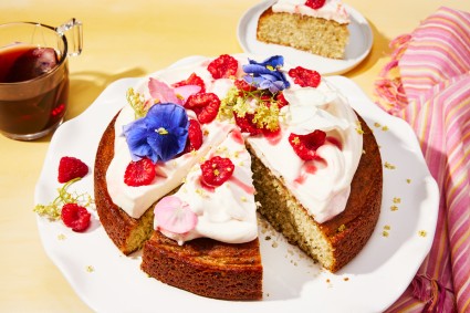Sliced Early Grey Cake decorated with fresh flowers