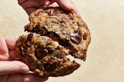 Sourdough chocolate chip cookies being broken in half