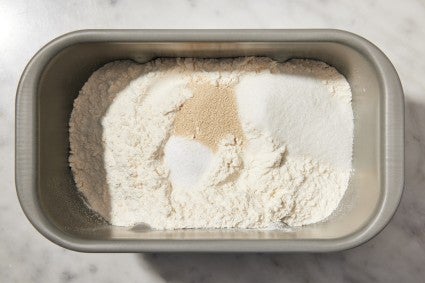 Bread machine bucket with dry ingredients