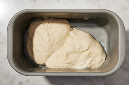Bread machine bucket with bread dough in it