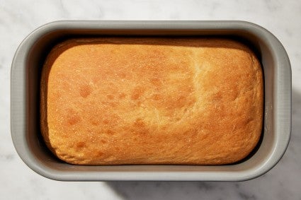 Bread machine bucket with baked bread in it