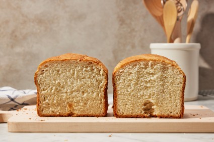 Side by side of interior of two bread machine loaves, one with a noticeable divot in the bottom middle, one without