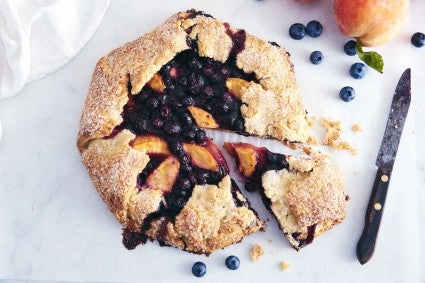 Image of pie from above with one slice cut out and a knife nearby.