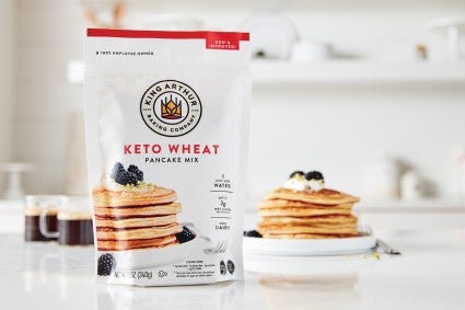 Bag of keto pancake mix in front of plate of keto pancakes