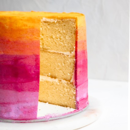 Sliced yellow, orange, and pink ombre cake