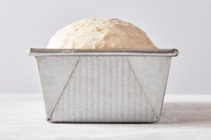 Proofing bread dough for sandwich bread, one inch over the top of the loaf pan