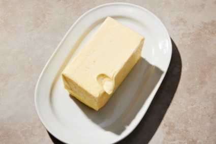 Stick of butter with indent left by a finger