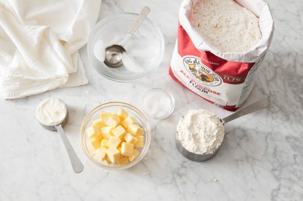 Flour, butter, salt, and other ingredients set out to make pie dough