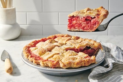 Slice of strawberry pie being lifted from pie plate