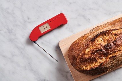 Thermapen thermometer next to loaf of bread