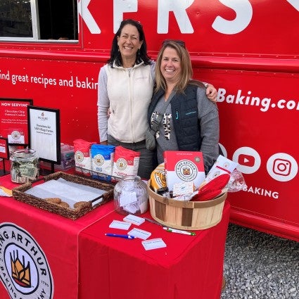 Bakers standing in front of King Arthur bake truck